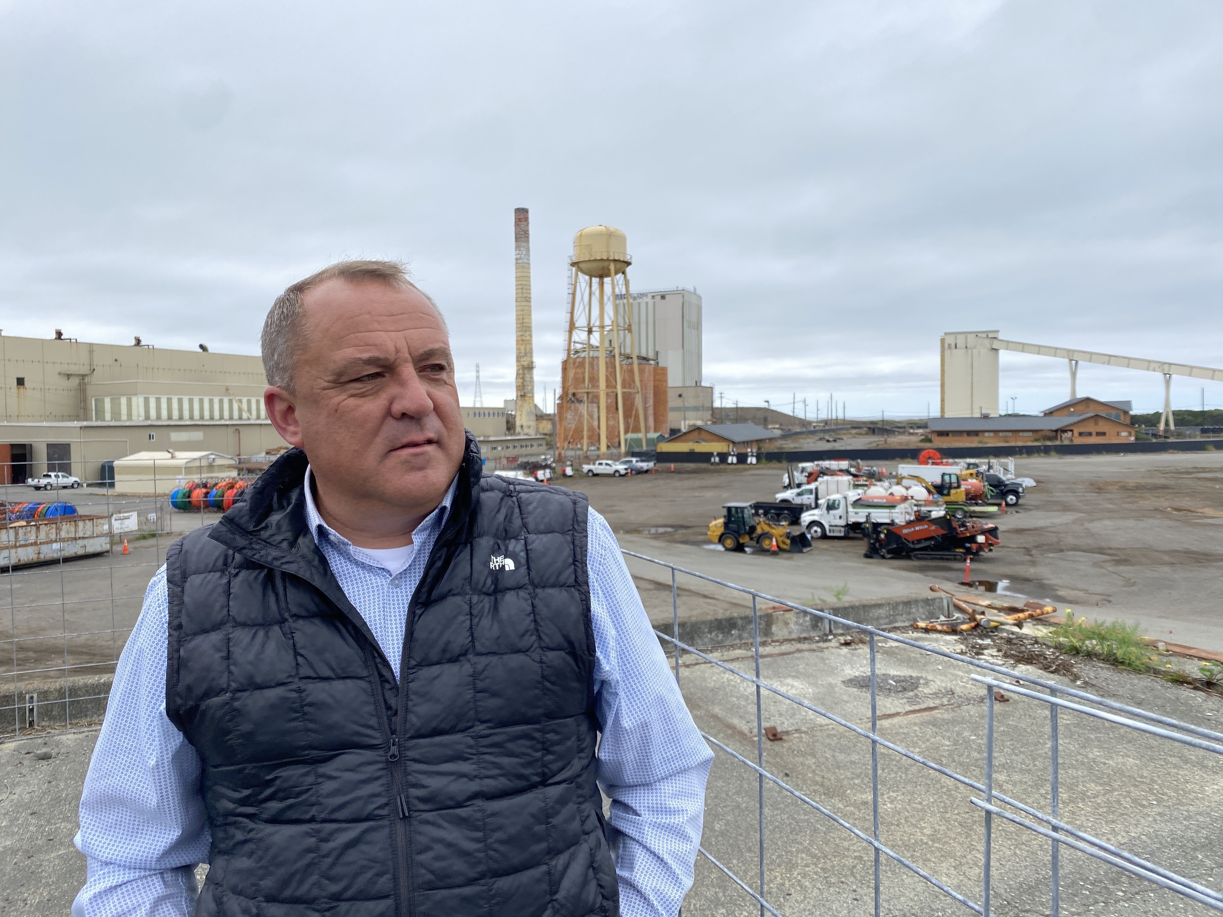 Chris Mikkelsen, executive director of the Humboldt Bay Harbor District, stands on the site of a planned marine terminal in Eureka, Calif. that will assemble wind turbines. The Trump administration recently canceled more than $426 million in federal grants for the port.